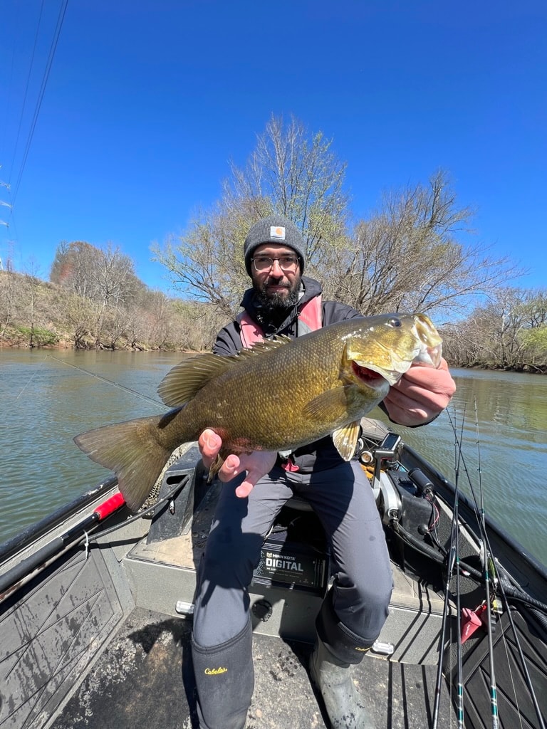 Angler holding large smallmouth bass catch